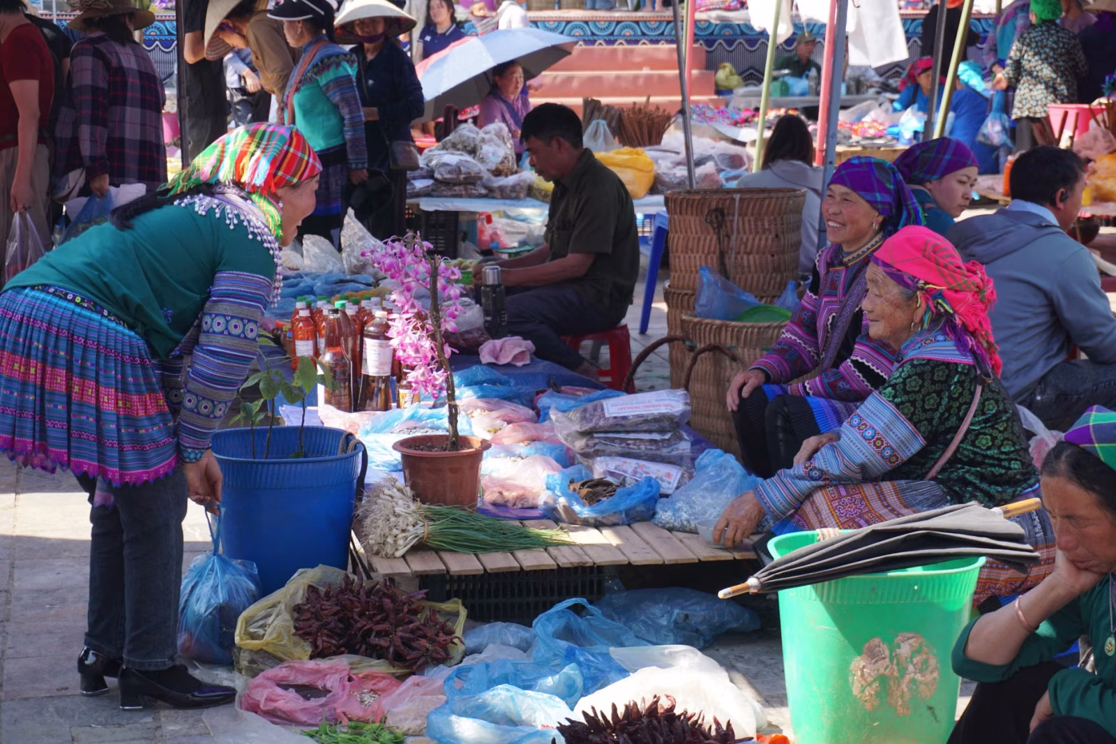 Vibrant scene of locals at Bac Ha Market, showcasing Hmong culture and traditional attire.